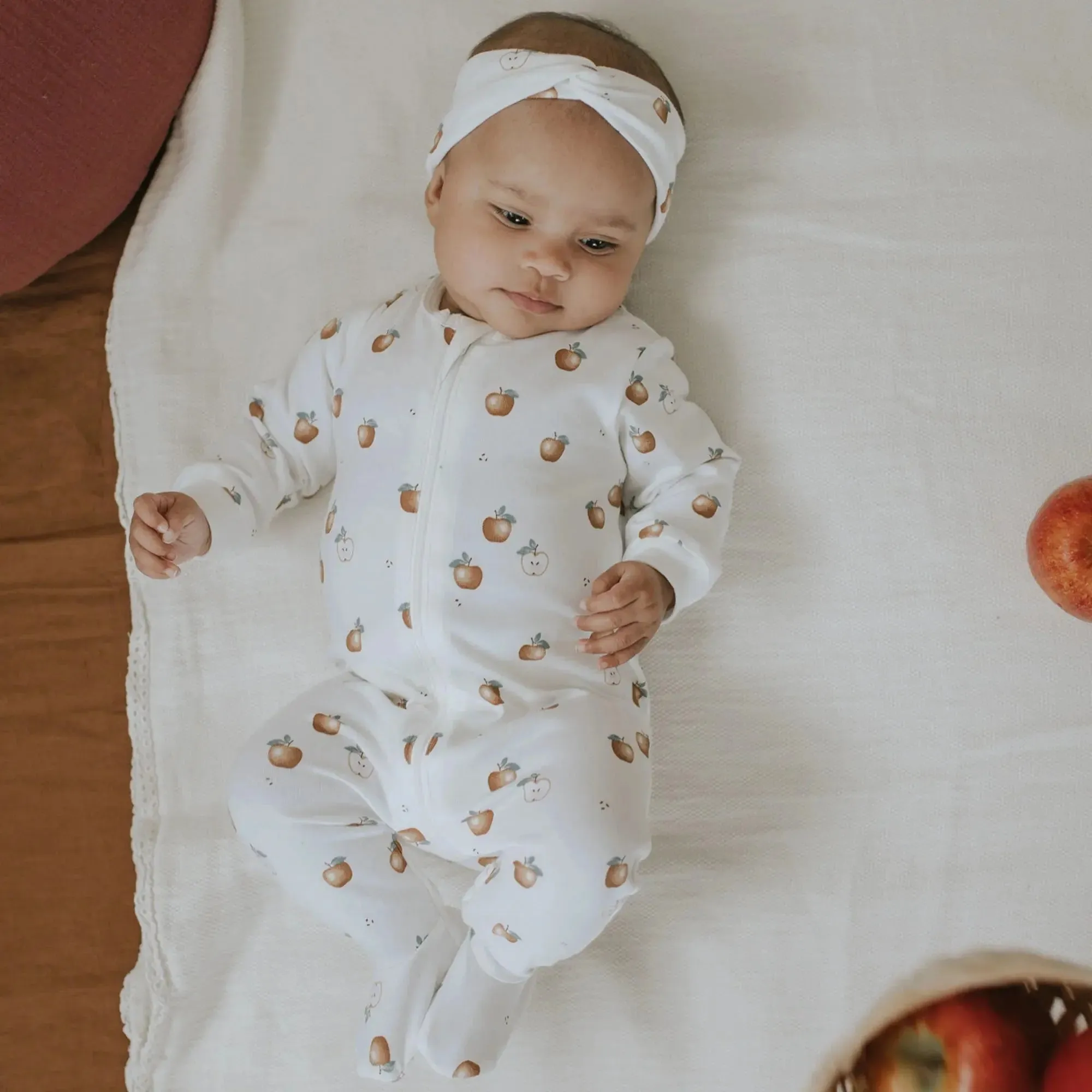 Golden Apples Print on Off-White Footed Sleeper | Petit Lem